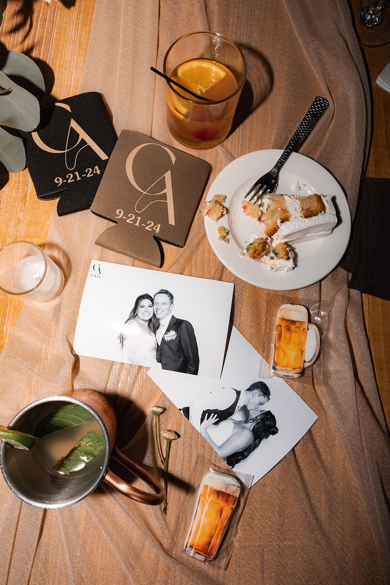 Printed photos from the booth laid out on a reception table