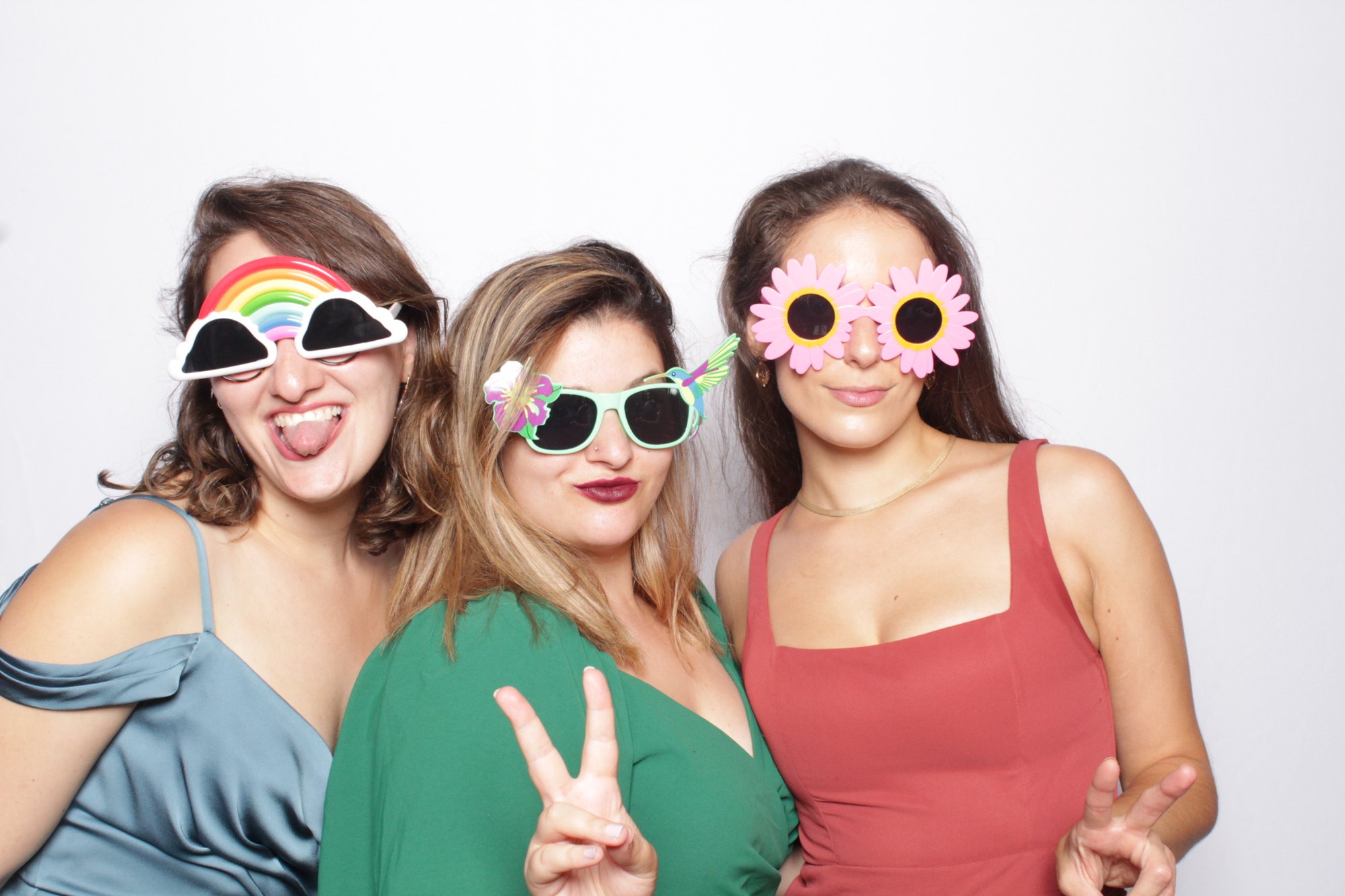 Guests in novelty sunglasses posing together at a celebration