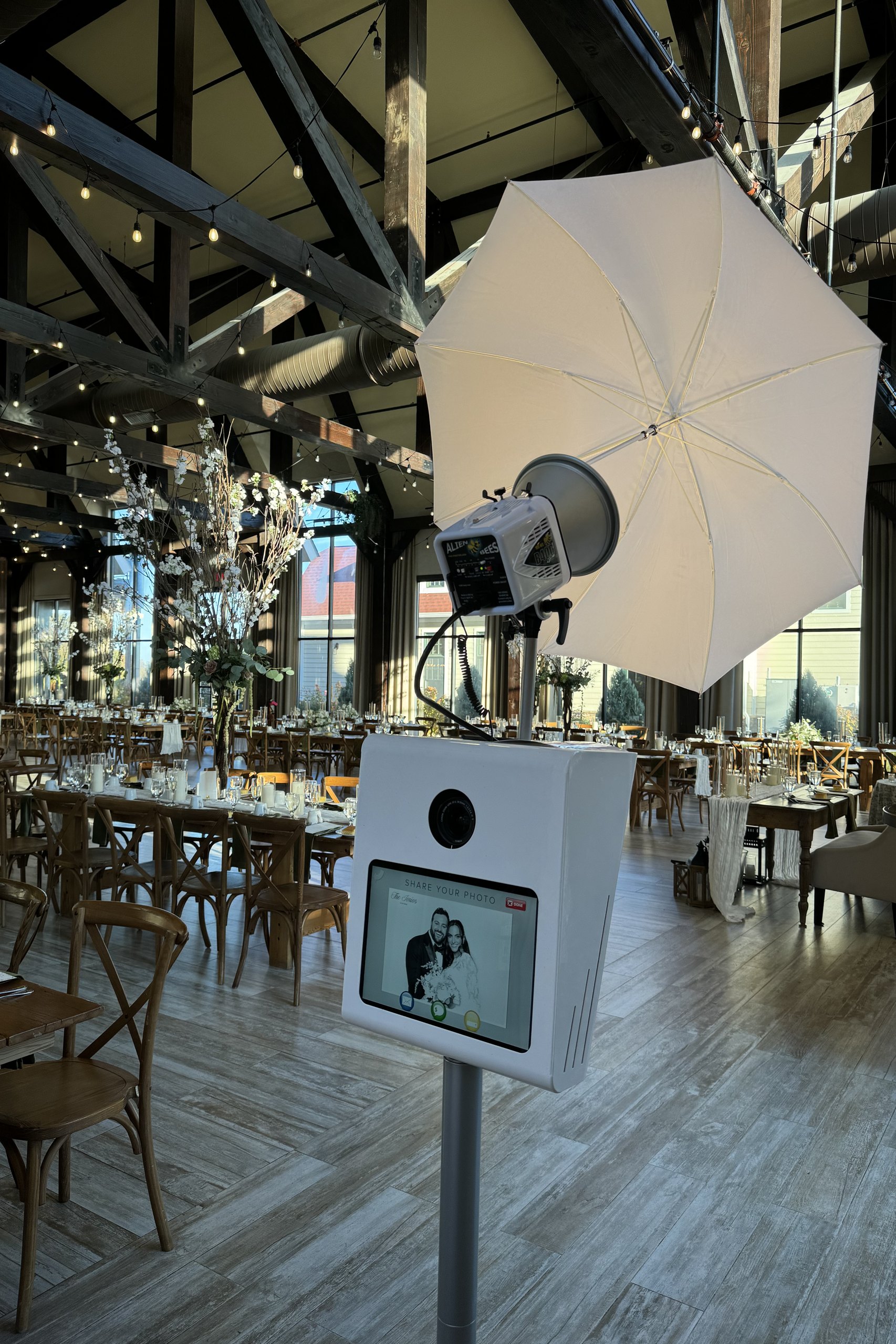 The booth set up in a venue under chandeliers for an evening event